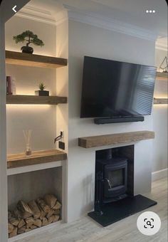 a flat screen tv mounted to the side of a wall next to a fire place