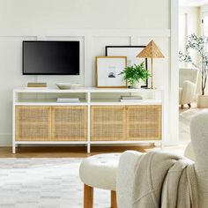 a flat screen tv sitting on top of a white entertainment center