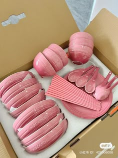 a box filled with pink plastic cups and saucers