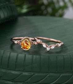 an orange and white ring sitting on top of a green tire treading surface with leaves