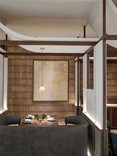 a dining room table with plates on it in front of a wall made out of wood