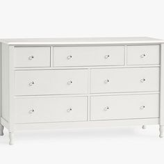 a white dresser with six drawers and two doors