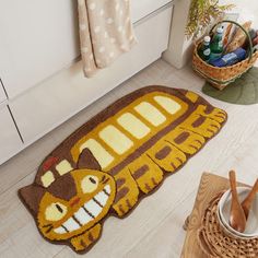 a yellow school bus rug on the floor next to a bowl and utensils