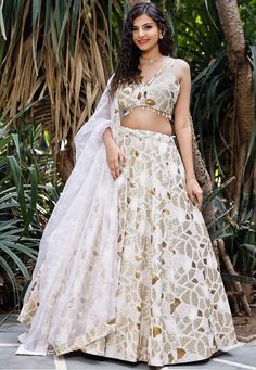 Faux Georgette Lehenga in White. This attire with Cotton Lining is Enhanced with Zari, Resham, Sequins Work along with Fancy Tassels and Potli. Available with a Readymade Faux Georgette White Choli and a Faux Georgette Dupatta in White. The Readymade skirt will be provided. Lehenga Length is 40 inched.Do Note: Accessories shown in the image are for presentation purposes only and length may vary upto 2 inches.(Slight variation in actual color vs. image is possible). We sell all kinds of Lehenga a White Organza Dupatta With Sequins, White Sequined Organza Dupatta, White Sequined Dupatta For Festivals, Festive Sequin Skirt Set For Wedding, White Sharara With Sequins For Navratri, Semi-stitched White Dupatta With Sequins, White Sequined Sharara For Navratri, Wedding Skirt Set With Mirror Work, White Organza Set With Pallu