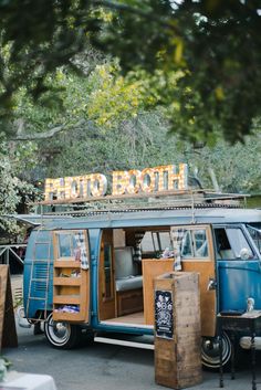 an old vw bus with the word retro booth on it's roof is parked in front of a tree