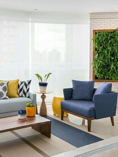 a living room filled with furniture and a green wall behind the couches in front of it