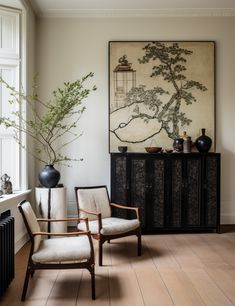 a living room filled with furniture and a large painting on the wall above a radiator