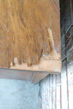 an old wooden table with peeling paint on it's edges and wood flooring