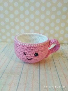 a crocheted cup with a face on it