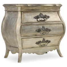 an ornate chest of drawers with three drawers