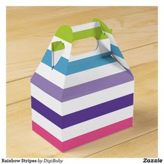 a colorful striped box sitting on top of a wooden table