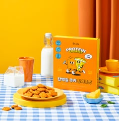 a table topped with cookies and milk on top of a blue and white checkered table cloth