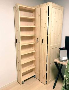 a large wooden cabinet sitting next to a computer desk