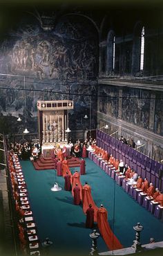 a large room filled with lots of red and purple chairs