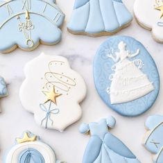 baby shower cookies are arranged on a marble countertop with blue and white decorations,