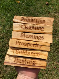 four wooden signs that say protection, cleaning, blessing, prosperity and ludicance