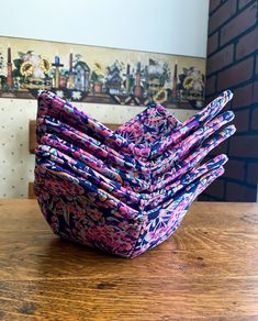 a stack of napkins sitting on top of a wooden table