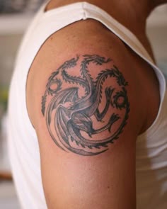 a man with a dragon tattoo on his arm