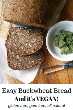 a loaf of bread sitting on top of a cutting board next to a bowl of pesto