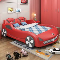 a child's bedroom decorated in red and grey with toy cars on the floor