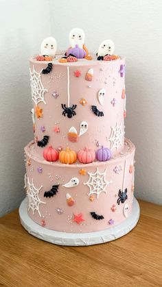 a three tiered cake decorated with halloween decorations