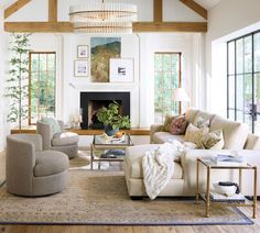 a living room filled with furniture and a fire place in the middle of a room