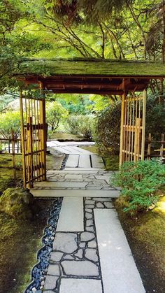 a stone path leading to a wooden gazebo