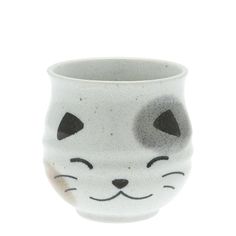 a white ceramic cup with a cat's face painted on it