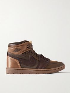 Nike's 'Method of Make' line takes iconic sneakers and elevates them with luxurious materials and details. Part of the series, this 'Air Jordan 1' pair is made from layered panels of leather, twill and satin in a rich tonal-brown colorway. Show off the high-top silhouette with shorts or cropped pants. Nike Leather Sneakers With Rubber Sole, Nike Luxury Sneakers, Luxury Nike Sneakers With Round Toe, Designer Leather Sneakers For Streetwear, Nike Leather Custom Sneakers With Rubber Sole, Designer Leather High-top Sneakers, Luxury Leather High-top Sneakers With Leather Sole, Nike Leather Sole Sneakers With Round Toe, Luxury Nike Round Toe Sneakers