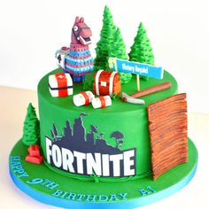 a birthday cake decorated with an image of a horse and trees on the top is for fortnite