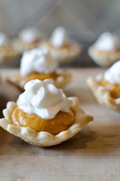 mini pumpkin pies with whipped cream on top