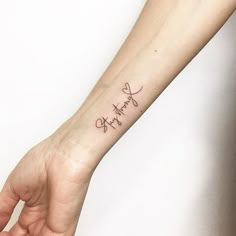 a woman's wrist tattoo with the word faith written in cursive font