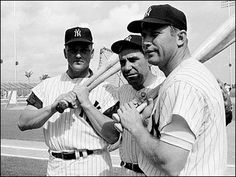 three baseball players are posing with their bats