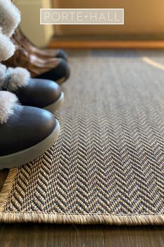 several pairs of shoes are lined up on the floor with pom - poms