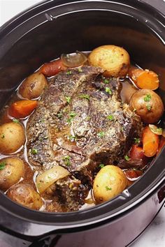 a pot with some meat and potatoes in it