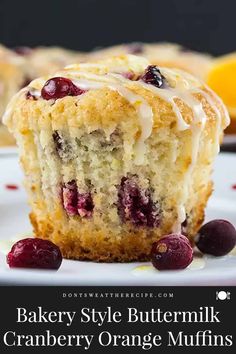 a close up of a muffin on a plate with cranberry orange muffins