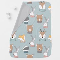 a blanket with animals on it next to marshmallows