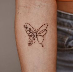 a woman's arm with a small tattoo on the back of her left arm