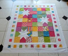 a colorful patchwork quilt on the floor