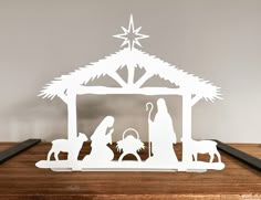 paper cut nativity scene with three wise men and baby jesus in the manger