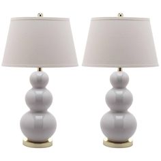 two lamps sitting next to each other on a white background