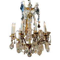 an antique chandelier with many crystal pieces