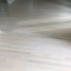 an empty living room with hard wood floors