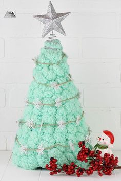 a christmas tree made out of cupcakes and icing with a star on top