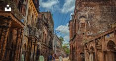 people are walking down the street in an old city