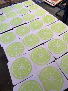 several pieces of paper cut out to look like lemons and oranges on a table