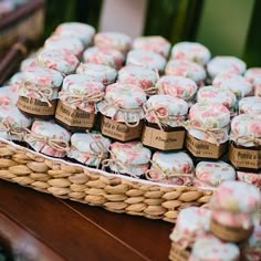 there is a basket full of soaps sitting on the table next to each other