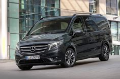 a black mercedes benz van parked in front of a building