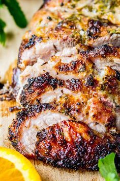 pork chops on a cutting board with lemon wedges and parsley garnish