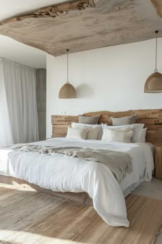 a bed with white linens and pillows in a bedroom next to a large window